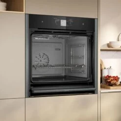 Neff N90 B64FT53G0B Bulit In Single Slide & Hide Electric Oven With Steam & Home Connect - Black With Graphite Grey Trim -Home Kitchen n e neff n90 b64ft53g0b slide and hide electric oven lifestyle2